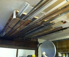 the ceiling in this kitchen is covered with metal pipes and duct tape that are attached to the ceiling