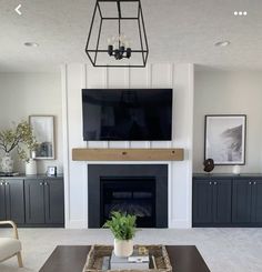 a living room with a large flat screen tv above the fireplace