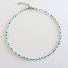 Mint green turquoise seed bead choker necklace, Beach necklace, Stainless steel jewelry The necklace is made with colorful Czech beads in size 10/0 (about 2 mm.) and stainless steel clasp. The length of the choker is 12 inches with an adjustable extender chain that is 2 inches long. The full length is 14 inches. Measure the length of your neck with a measuring tape or you can use any string, rope or phone cable, and afterward apply the measurements on a regular ruler. Summer Green Choker With Tiny Beads, Green Choker With Colorful Beads For The Beach, Green Necklace With Faceted Beads For Beach, Beach Choker With Colorful Green Beads, Adjustable Turquoise Beaded Nickel-free Necklace, Vert Turquoise, Beach Necklaces, Beaded Choker Necklace, Green Turquoise