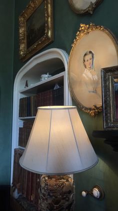 a lamp sitting on top of a table next to a book shelf filled with books