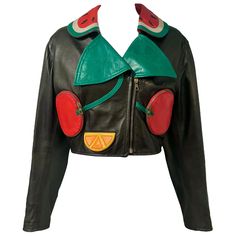 Whimsical rare vintage Moschino black cropped moto leather jacket with colorful fruit appliques. This unique jacket features a watermelon collar, cherry zip pockets, oranges, cherry cuffs, and bananas. Embroidered with "SIAMO ALLA FRUTTA!" on the back. Size: There is no size tag present, please refer to measurements for the best fit. Condition: In excellent condition with light wear throughout. Measurements: Bust- 34" Waist- 30" Length- 20" Note that this piece has lived a previous life, and its Atom Punk Fashion, Funky Leather Jackets, Vintage Cropped Leather Jacket, Moschino 90s, Wacky Fashion, Fun Jackets, Funky Jacket, Retro Futurism Fashion, Moschino Vintage 1990s