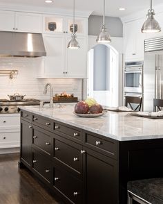 an image of a kitchen with white cabinets and stainless steel appliances on the phone screen