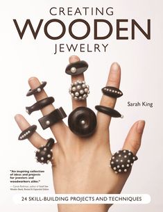 a book cover with an image of a hand holding several rings and beads on it