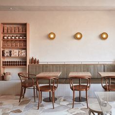 an empty restaurant with wooden tables and chairs