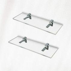 two glass shelves with metal brackets on them