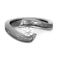 a white gold ring with a diamond in the center and two curved bands around it