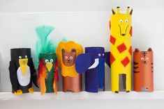 some paper mache animals are lined up on a shelf