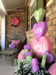 some pink and green hearts are on the front porch