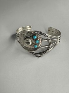 Sterling silver cowboy hat and rope cuff, set with three small round turquoise. Solid, Sturdy and Substantial! One size fits most. Western Sterling Silver Cuff Bracelet With Concho, Western Turquoise Bracelet With Concho, Western Style Turquoise Bracelet With Concho, Western Turquoise Bracelets With Concho, Western Sterling Silver Bracelets, Western Sterling Silver Cuff Bracelet, Adjustable Western Sterling Silver Cuff Bracelet, Western Style Sterling Silver Bracelets, Western Style Sterling Silver Cuff Bracelet