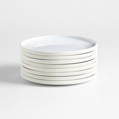 six white plates stacked on top of each other