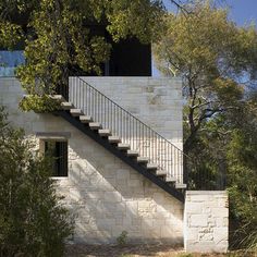 a white brick building with stairs leading up to it