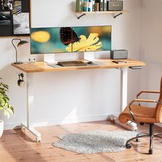 a computer desk with a laptop on it and a chair in front of the monitor