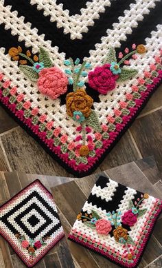 two crocheted squares with flowers on them, one is black and the other is white