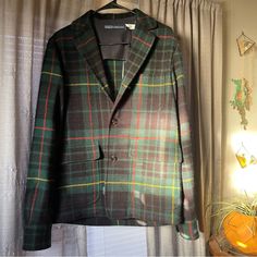 Crafted Of Plaid Tweed, Polo Ralph Lauren’s Sports Coat. Features: Button Cuffs. Notch Lapels Long Sleeves, Button Cuffs Chest Patch Pocket Side Flap Pockets Button-Front Closure Casual Plaid Tweed Outerwear, Tailored Plaid Wool Sport Coat, Green Wool Sport Coat For Work, Green Tweed Business Blazer, Long Sleeve Tweed Sport Coat, Green Tweed Business Outerwear, Green Tweed Outerwear For Business, Plaid Tweed Outerwear With Welt Pockets, Tailored Green Tweed Outerwear