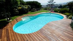 an above ground pool surrounded by wooden decking