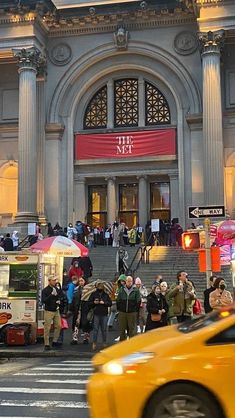 people are standing in front of the metropolitan building