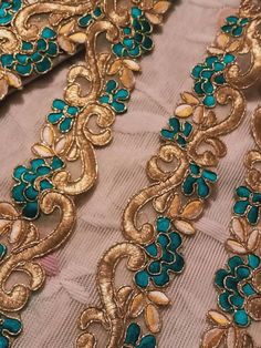 an embroidered fabric with gold and blue details