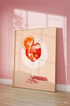 an orange slice in a wine glass on a pink wall