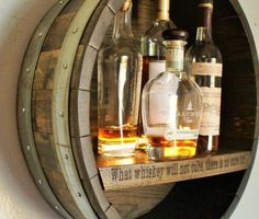 several bottles of alcohol sitting on top of a wooden barrel