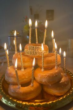 a birthday cake made out of doughnuts with candles