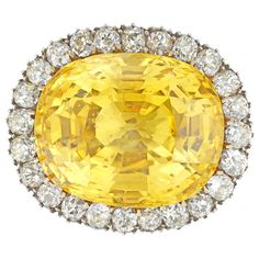 An Important Victorian yellow sapphire and diamond brooch/ring, the natural sapphire weighing 31.58 carats, accompanied by GCS Report stating to be of Sri Lankan origin with no indication of heating, claw-set in yellow gold, surrounded by twenty four old European-cut diamonds estimated to weigh 2.4 carats in total, all set in silver cut-down setting, to yellow gold mount and brooch fitting, circa 1890, with associated gold ring, the head measuring 2.5 x 2.1 cm, finger size L, gross weight 19gram Yellow Sapphire Ring, Canary Diamond, Silk Evening Gown, Antique Brooches, Diamond Brooch, Gold Ring Sets, European Cut Diamonds, Yellow Sapphire, Natural Sapphire