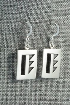 These sterling silver earrings are made by Hopi silversmith Timothy Mowa. The backs are signed and stamped sterling.Length: 1 3/8"Width: 5/8"Free shipping on all orders! We ship with USPS and always include tracking. All orders ship within a day of payment.Returns are accepted up to 30 days after you receive your order. Just send us a message. Our shop offers cash back or store credit. The item must be returned in new condition. Silver Symbolic Rectangular Jewelry, Traditional Sterling Silver Rectangular Jewelry, Unique Sterling Silver Rectangular Earrings, Traditional Rectangular Sterling Silver Jewelry, Symbolic Hallmarked Sterling Silver Earrings, Native American Jewelry, Free Jewelry, Sterling Silver Earrings, Silver Earrings