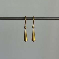 Stately everyday earrings that unite form with fluidity. 22k yellow gold Tapered pod is 5mm x 18mm (3/16" x 3/4")Earrings hang 1 3/16" from the earEach earring weighs 2.4g Contemporary Teardrop Yellow Gold Earrings, Contemporary Yellow Gold Teardrop Earrings, Contemporary Everyday Drop Earrings, Brass Drop Earrings For Formal Occasions, Modern Formal Earrings In Recycled Gold, Modern Recycled Gold Earrings For Formal Occasions, Modern Recycled Gold Earrings For Formal Events, Contemporary Yellow Gold Drop Earrings, Brass Drop Single Earring