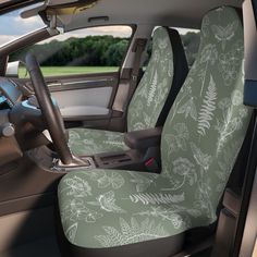 the interior of a car with green and white floral seat covers