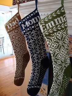 three christmas stockings hanging from a fireplace