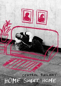 a man laying on the ground in front of a wall with red writing that reads home sweet home