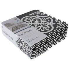 a stack of black and white paper with an intricate design on the bottom, in front of a white background