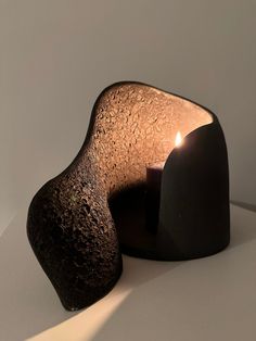 a candle that is sitting on top of a table next to a heart shaped object