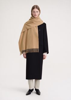 Classic TOTEME scarf made in Italy from responsibly sourced wool. It has a rectangular shape measuring 220x50cm with fringed edges and a monogram label. Wear it throughout winter over your favorite coat or jacket. Luxury Beige Scarf For Fall, Fall Beige Outerwear With Scarf, Classic Beige Scarf For Fall, Classic Beige Scarves For Fall, Beige Wool Shawl For Fall, Elegant Beige Wool Scarf, Fall Beige Wool Shawl, Classic Shawl Scarf For Fall, Classic Fall Shawl Scarf