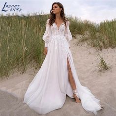 a woman standing on top of a sandy beach wearing a white dress and high heels