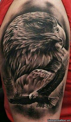 an eagle tattoo on the back of a woman's arm, with black and grey ink