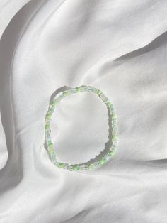 This bracelet is a beautiful mix of white and green shades. Green And Yellow Bracelet, Yellow Bracelet, White Shades, Green Shades, Green Bead, Green And White, Shades Of Green, Arm Band, San Diego