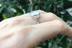 "A minimalist simple square-shaped faceted moonstone ring in Sterling Silver featuring a comfort fit band with a bezel around the stone. These moonstone are white with minimal flash. Wrapped in a box ready for gift giving.(r-new-12) *Since this is a natural stone each ring will vary in color RING INFO ---------------- STERLING SILVER 11.5mm Model's Ring Size 5 *Follow us @belesasjewelry on Instagram for promotions/giveaways *LIKE* us on Facebook http://www.facebook.com/Belesas to find special co Pink Gemstone Engagement Rings, Silver Ring Simple, Sterling Silver Rings Simple, June Birthstone Ring, Moonstone Ring Sterling Silver, Silver Rings Simple, Blue Moonstone, Promise Rings For Her, June Birthstone