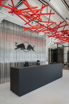 an office with red and black decorations hanging from the ceiling