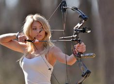 a beautiful blond woman holding a bow and arrow