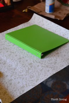 a green binder sitting on top of a table