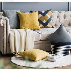 a living room filled with furniture and pillows