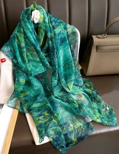 Introducing a stunning green evening scarf, perfect for any formal occasion. Made of a luxurious blend of polyester and viscose, this multifunctional scarf is versatile and comfortable to wear. The intricate chiffon fabric type adds a touch of elegance, while the pashmina, shawl, and wrap style give it a unique look. Ideal for weddings and other special events, this scarf is a must-have accessory for any fashion-forward woman. The scarf is suitable for all seasons, making it a perfect addition t Evening Scarf, Beach Scarf, Sarong Dress, Scarf Yarn, Luxury Printing, Beautiful Ladies, Long Scarf, Fashion Pattern, Look Casual