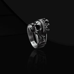 King Crown Skull Gothic Ring Introducing our striking and captivating King Skull with Crown Gothic Mens Ring in Sterling Silver. This cool and attention-grabbing biker goth skull ring is the perfect accessory for your boyfriend. Its unique design and meticulous craftsmanship make it a must-have for any gothic fashion enthusiast. Add a touch of edgy charm to any outfit, especially during Halloween, with this eye-catching pinky ring. It also makes for a thoughtful and exquisite family gift. Crafted with sterling silver, this ring embodies durability and style. Express your individuality and embrace the dark side with this one-of-a-kind piece. Item Details Male - Female Product Code: FRKG102 Product Name: King Crown Skull Gothic Ring Metal: Handmade red enameled oxidized 925 Sterling Silver R Boyfriend Halloween, Skull With Crown, Silver King, Gothic Ring, King Crown, 22 Carat Gold, Gothic Rings, Ring Men, Mens Ring