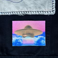 an altered photograph of a flying saucer in the sky with clouds on it's side