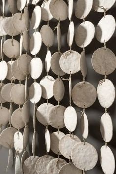 a group of metal discs hanging on a wall