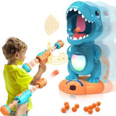 a young boy playing with an interactive toy dinosaur that looks like he's having fun