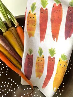 carrots and radishes are on a dish towel