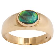 Set with a natural oval black opal of warm ocean blue green color this ring is nature showing its most rare of the opal family. There is a spectrum of color in this Australian opal, a dark tone with flashings within of dark and light shades of green, blue and black. It is vibrant to the eye and the color resounds in your core. Australian black opals were first removed from a ridge in the 1901. Ancient Greeks believed the stone kept its owner from disease. The European population tagged the black opal as a symbol of purity, hope and truth. he Opal stone represents amplification, higher hope, and divine purity. These light dancing gemstones are here to boost those feelings of balance and peace and to help you to sift through your thoughts and feelings and throw out what doesn't work. Spiritu Australian Black Opal, Black Opal Ring, Blue Green Color, Dark And Light, S Jewelry, Opal Stone, Australian Opal, Opal Ring, Black Opal