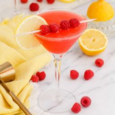 a raspberry lemonade martini is garnished with fresh raspberries