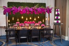 the table is set up with candles and flowers on it for an elegant dinner party